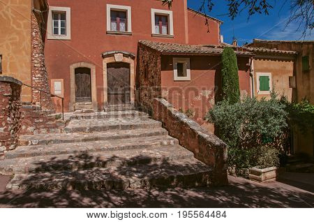 Roussillon, France - July 03, 2016. View of traditional colorful house in ocher and staircase, in the historic Roussillon. Located in the Vaucluse department, Provence region, southeastern France