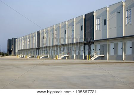 Newly Constructed Large Empty Warehouses On A Summer Morning.