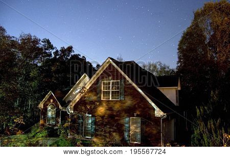 Stars over a home in last evening hours early winter.