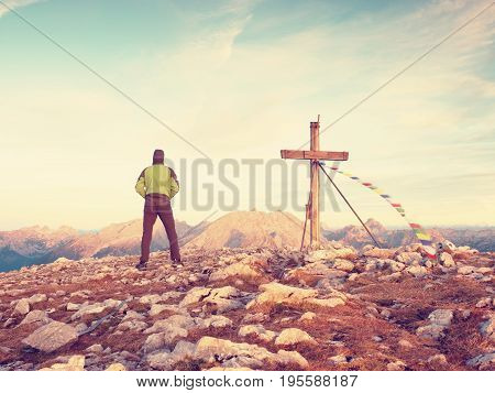 Alone Man Climber Near The Summit Cross On Peak, Dolomite Alps, Austria. Sunny Windy Evening.