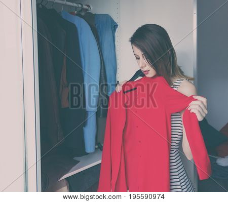 Young Rednead Girl Choosing A Clothes