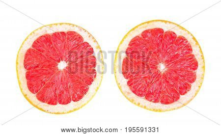 Close-up two perfect halves of a delicious grapefruit isolated over the white background. Colorful sour grapefruit chopped in half. Tasty natural summer fruits.