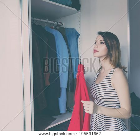 Young Rednead Girl Choosing A Clothes