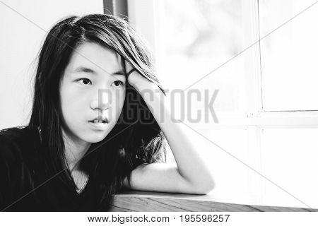 Depress And Hopeless Girl With Absent Minded Looking Outside