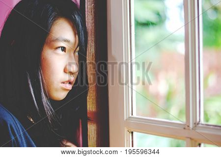 Depress And Hopeless Girl With Absent Minded Looking Outside