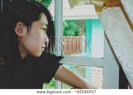 Depress And Hopeless Girl With Absent Minded Looking Outside