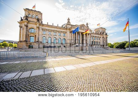 View on the famous Reichtag parliament building with flag during the morning light in Berlin city