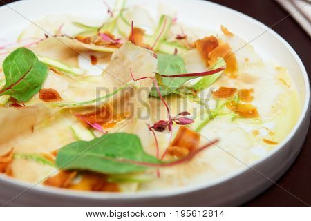 Carpaccio from artichoke and bottarga roe, Italian dish