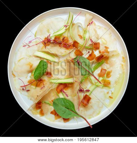 Carpaccio from artichoke and bottarga roe isolated on black background