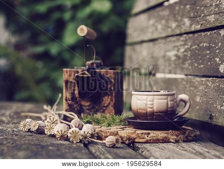 country house stillife with utensils and flowers poppies on a wooden background