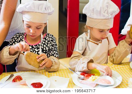 Alchevsk, Ukraine - July 16, 2017: Children's Master Class On Cooking Potatoes In The Oven With Ham 