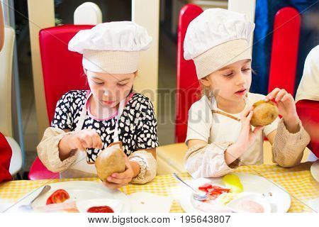Alchevsk, Ukraine - July 16, 2017: Children's Master Class On Cooking Potatoes In The Oven With Ham 