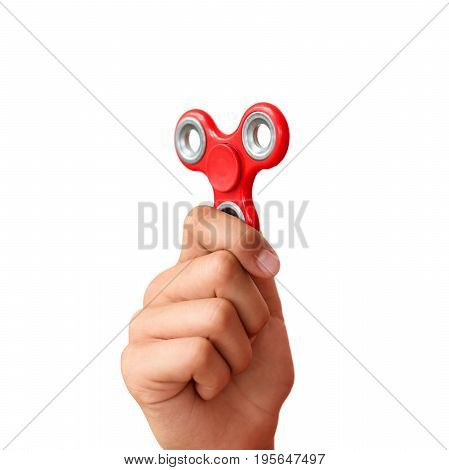 Red hand spinner. Boy playing a popular toy fidget spinner in his hand. Stress relief. Anti stress and relaxation adhd attention fad boy concept