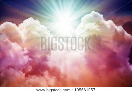 Abstract. Fog and clouds looking up into a fantasy multicolored sky. The bright red sun illuminates the whole picture.