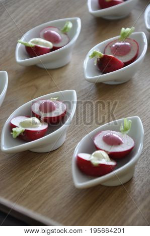 Radishes presented with sauce on a platter