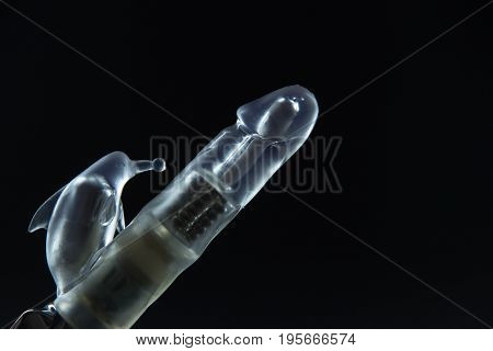 Sex toys on a black background. Large dildo vibrator with batteries.
