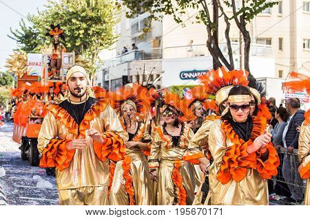 LIMASSOL, CYPRUS - FEBRUARY 26: Carnivalists in a silver cylinder hats joyfully follow the Limassol Municipality Band during the annual Carnival Parade, February 26, 2017 in Limassol.