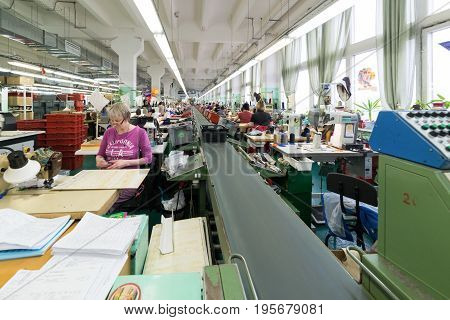 Shoe Factory. Female Worker On A Sewing Machine.