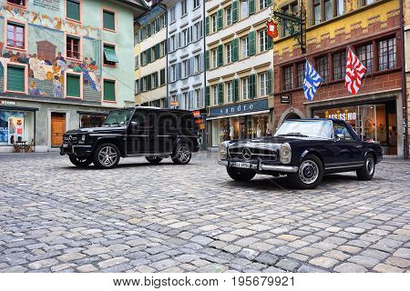 LUCERNE SWITZERLAND - JUNE 14 2017: Vintage oldtimer and modern Mercedes cars parked on the picturesque Weinmarkt square in Luzerne