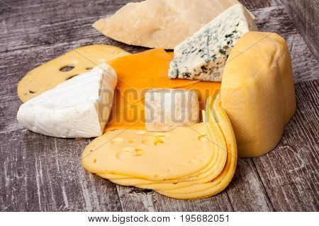 Different type of cheese on wooden background. Gourmet food apetizer