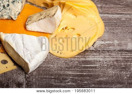 Different type of cheese on wooden background. Gourmet food apetizer
