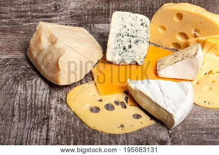 Different type of cheese on wooden background. Gourmet food apetizer