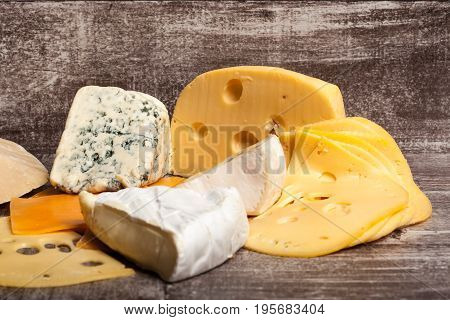 Different type of cheese on wooden background. Gourmet food apetizer