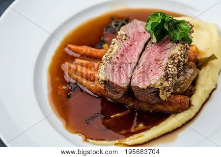 medium done grilled tuna steak in batter served with the baby carrot and mashpotato