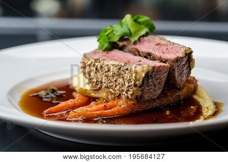 medium done grilled tuna steak in batter served with the baby carrot and mashpotato