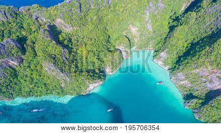 Aerial drone view of iconic tropical turquoise water Pileh Lagoon surrounded by limestone cliffs, Phi Phi islands, Thailand