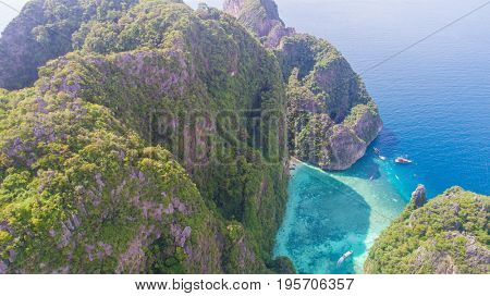 Aerial drone view of iconic tropical turquoise water Pileh Lagoon surrounded by limestone cliffs, Phi Phi islands, Thailand