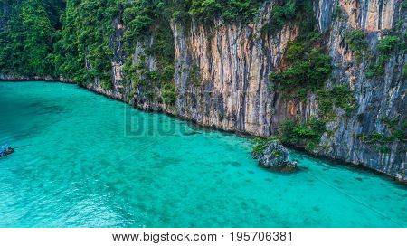 Aerial drone view of iconic tropical turquoise water Pileh Lagoon surrounded by limestone cliffs, Phi Phi islands, Thailand