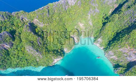Aerial drone view of iconic tropical turquoise water Pileh Lagoon surrounded by limestone cliffs, Phi Phi islands, Thailand