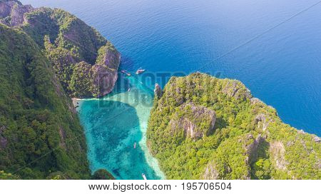 Aerial drone view of iconic tropical turquoise water Pileh Lagoon surrounded by limestone cliffs, Phi Phi islands, Thailand