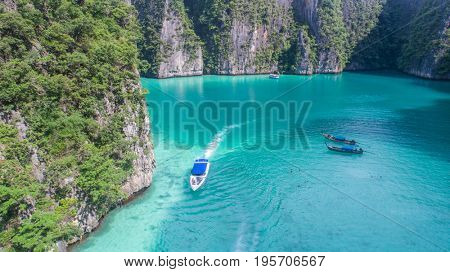 Aerial drone view of iconic tropical turquoise water Pileh Lagoon surrounded by limestone cliffs, Phi Phi islands, Thailand