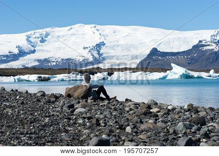 Woman looking over Jokulsarlon a glacial lagoon Iceland