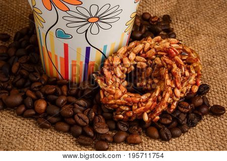 Cup Of Coffee, Biscuits And Coffee Beans On A Wooden Background