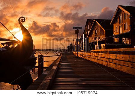 Seafront on the sunset with Viking ship