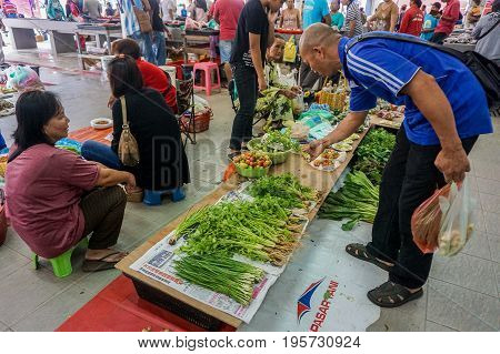 Keningau,Sabah,Malaysia-June 29,2017:Local people buying various vegetables at the local market Tamu in Keningau,Sabah.Its a place where all farmers,fishermen & vendors gathers weekly to sell their products