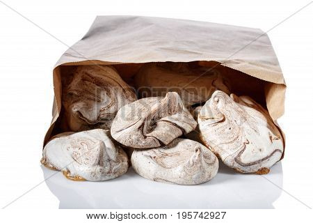 Homemade marble chocolate meringue cookies in paper bag Isolated on white