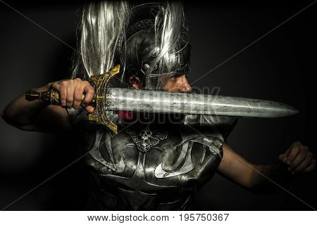 Caesar, Roman centurion with armor and helmet with white chalk, steel sword and long red cape