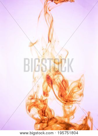 Ink swirl in a water on color background. The paint splash in the water. Soft dissemination a droplets of colored ink in water close-up. Abstract background. Explosion of splashes acrylic ink.