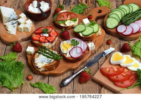Set Of Healthy Whole Wheat Bread Sandwiches With Fuits, Vegetables, Cheese And Leafy Green Herbs On