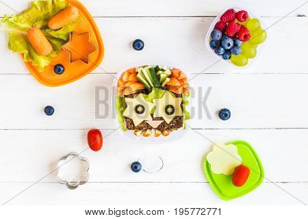 School lunch box for kids on white wooden background. Back to school. Top view flat lay