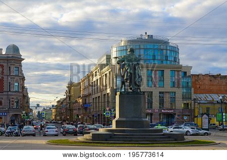 SAINT PETERSBURG RUSSIA - MAY 3 2017: Unknown people walk along Zagorodny prospect and Gorokhovaya street. Monument to A.S. Griboyedov in evening sunset light St. Petersburg Russia
