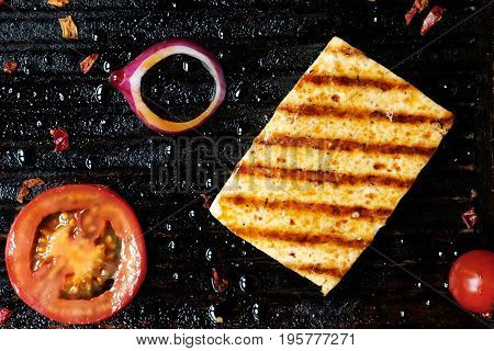 ofu on the grill on the table on a black background, view from the top