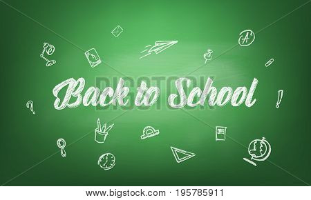 Back to school. Blackboard with chalk written typography back to school and hand drawn chalk scetches. Green blackboard