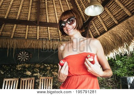 Hot sexy young woman at billiards club outside the tropics. Tropical billiards table on Nusa Lembongan, Bali island.