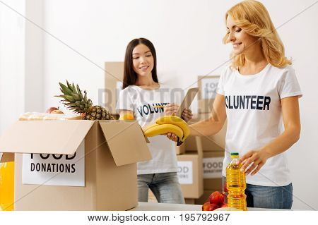Scrupulous work. Dedicated capable intelligent women making sure they not missing anything while packing boxes and shipping them to those in need