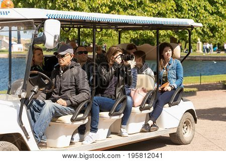 St. Petersburg Russia - June 28 2017: tourists visiting the park on an electric car. Peterhof in St. Petersburg